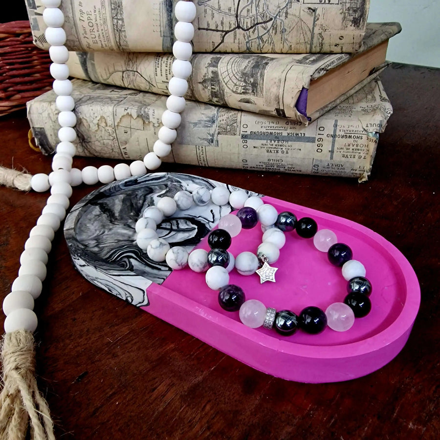 decorative resin tray in pink and black&white that is made from diy resin casting kit. Used with braceletes in it.